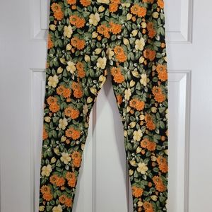 Lularoe TC leggings.  Yellow orange green flowers on black leggings.